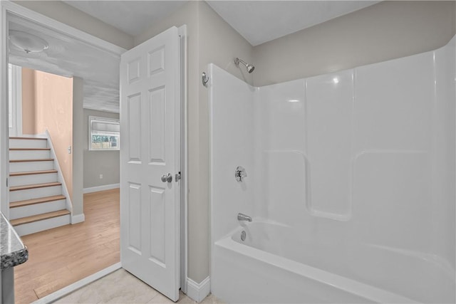 bathroom with tile patterned floors and shower / bathtub combination