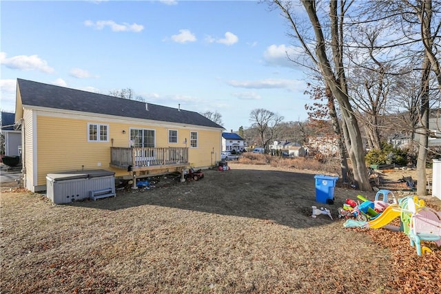 back of property with a wooden deck