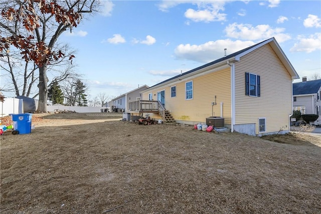 view of property exterior featuring a wooden deck and cooling unit