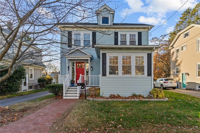 view of property featuring a front lawn