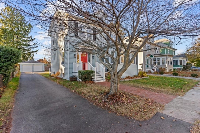 view of front of house with a garage and an outdoor structure