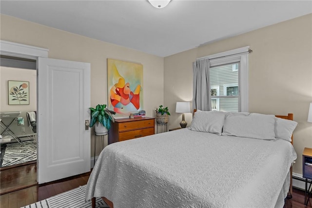 bedroom with dark wood-type flooring and a baseboard radiator