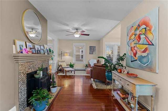 living room with ceiling fan, dark hardwood / wood-style flooring, and a baseboard radiator