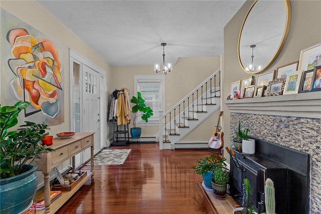 entrance foyer featuring a baseboard radiator, a notable chandelier, and dark hardwood / wood-style flooring