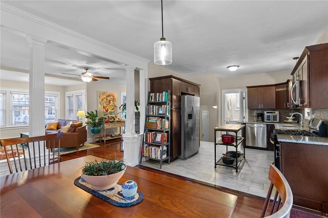 dining room featuring ceiling fan, light hardwood / wood-style flooring, and ornate columns