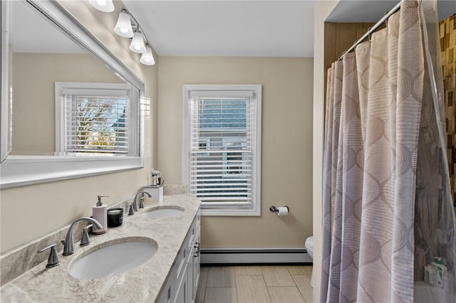 bathroom with vanity, a shower with shower curtain, toilet, and baseboard heating