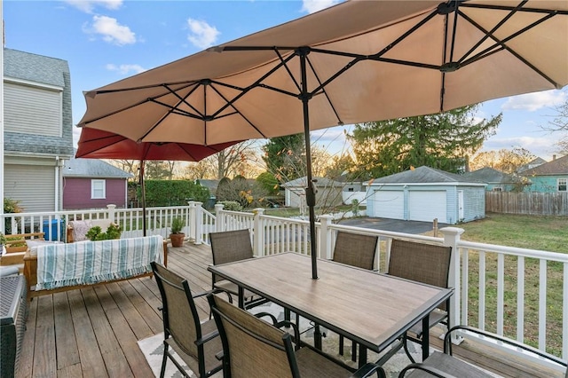 wooden deck featuring a yard, a shed, and a garage