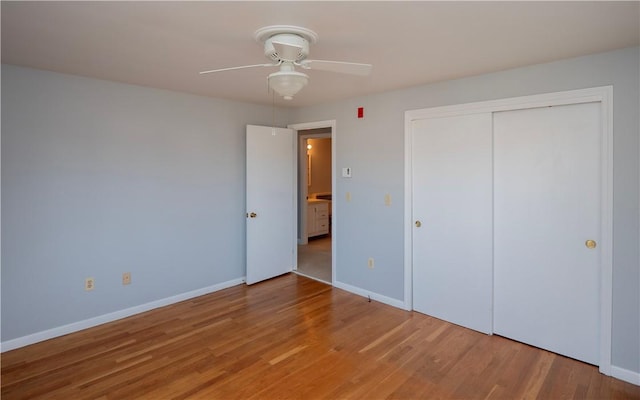 unfurnished bedroom with wood-type flooring, ceiling fan, and a closet