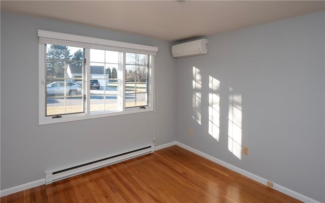 unfurnished room with wood-type flooring, a baseboard heating unit, and a wall mounted air conditioner