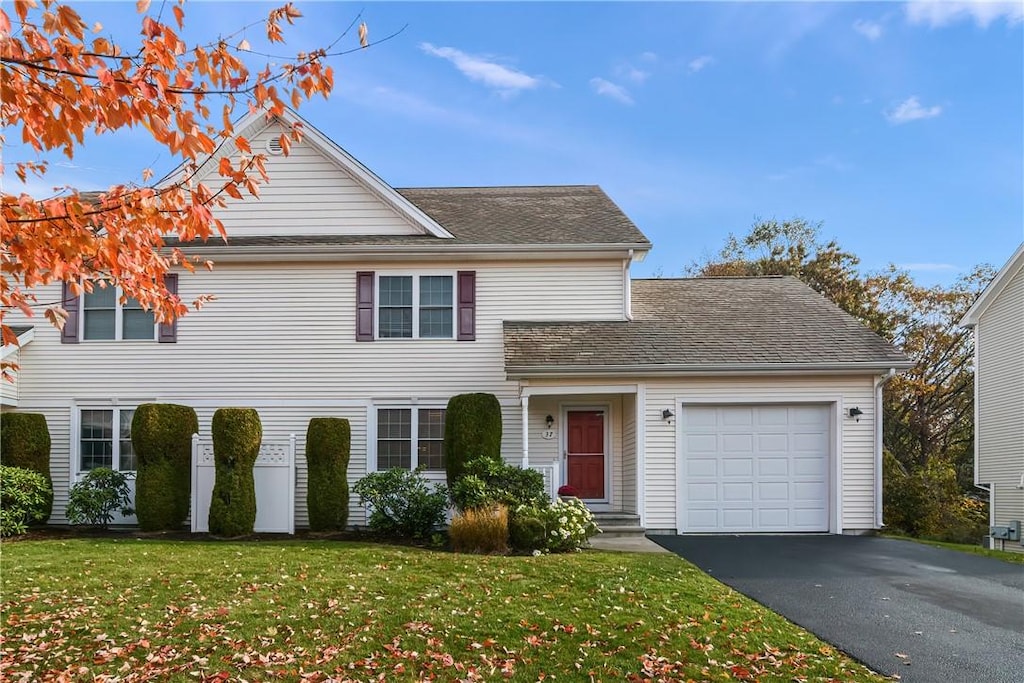 view of front of home featuring a garage and a front lawn