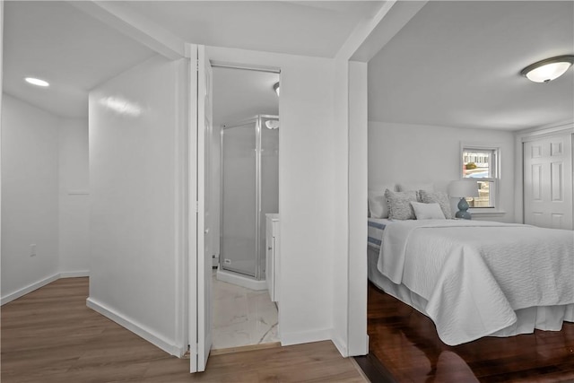 bedroom featuring hardwood / wood-style floors and connected bathroom