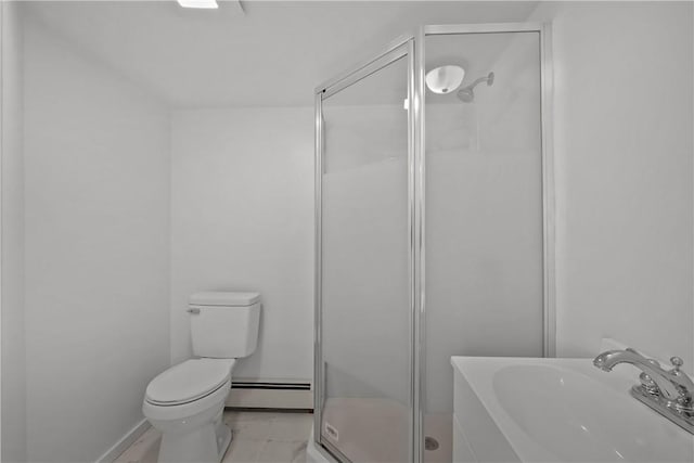 bathroom with an enclosed shower, sink, toilet, and baseboard heating