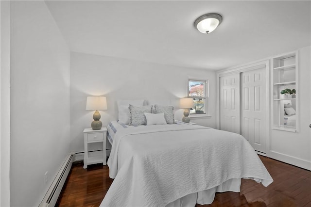 bedroom featuring a baseboard radiator, dark wood-type flooring, and a closet