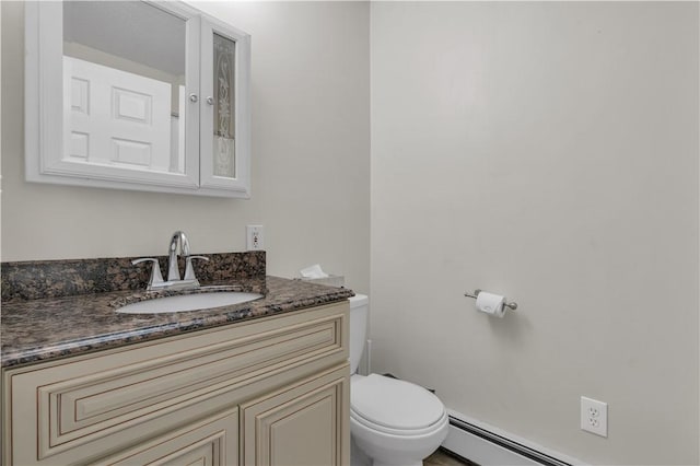 bathroom featuring baseboard heating, vanity, and toilet