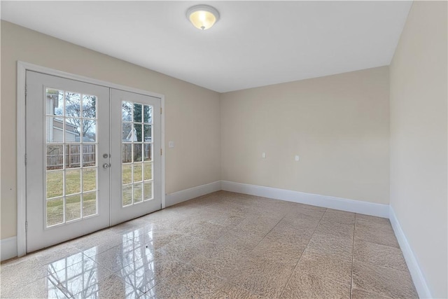 unfurnished room featuring french doors