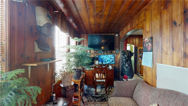 living room featuring wooden walls and wood ceiling