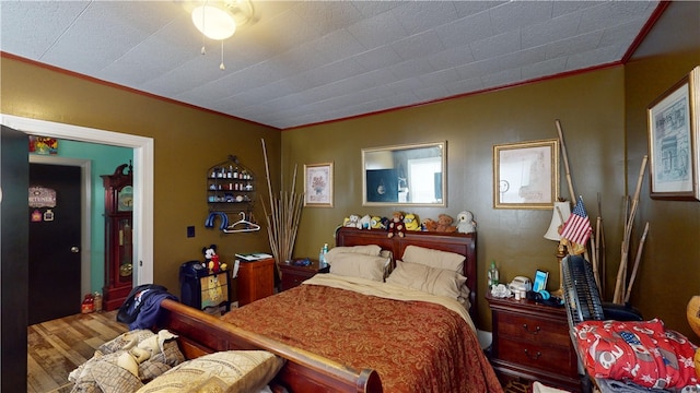 bedroom featuring hardwood / wood-style flooring and ornamental molding