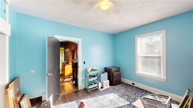 misc room featuring ceiling fan and dark hardwood / wood-style floors