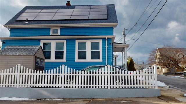 view of front of house featuring solar panels