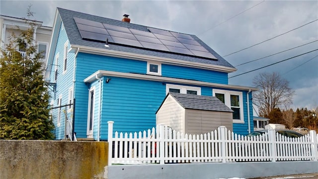 view of front facade with solar panels