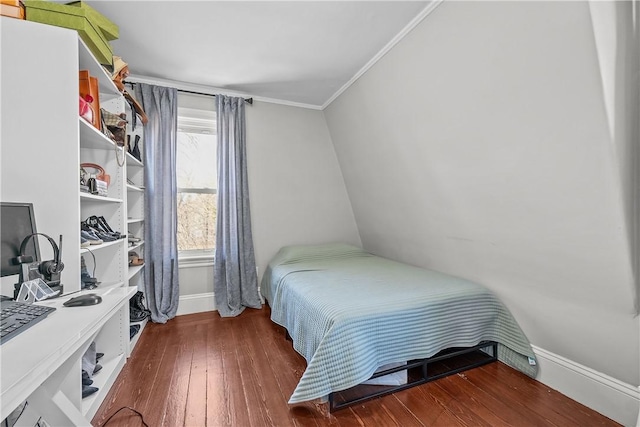 bedroom with crown molding and dark wood-type flooring