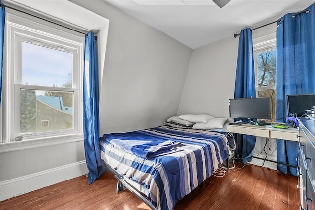 bedroom with dark hardwood / wood-style floors and ceiling fan