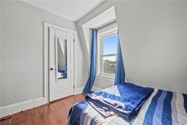 bedroom with hardwood / wood-style flooring