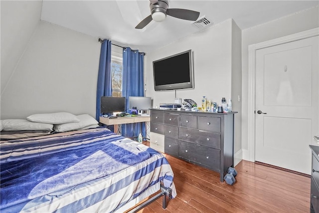 bedroom with ceiling fan and dark hardwood / wood-style flooring