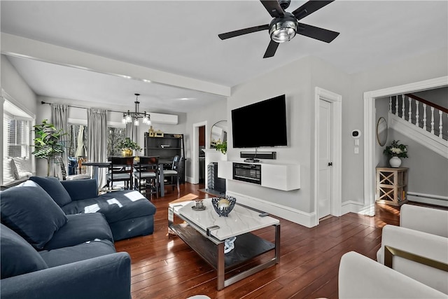 living room with dark wood-type flooring, ceiling fan with notable chandelier, and baseboard heating