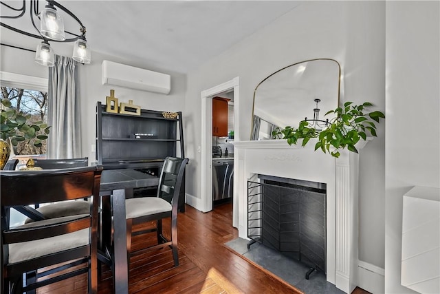 dining area with dark hardwood / wood-style flooring and a wall mounted AC