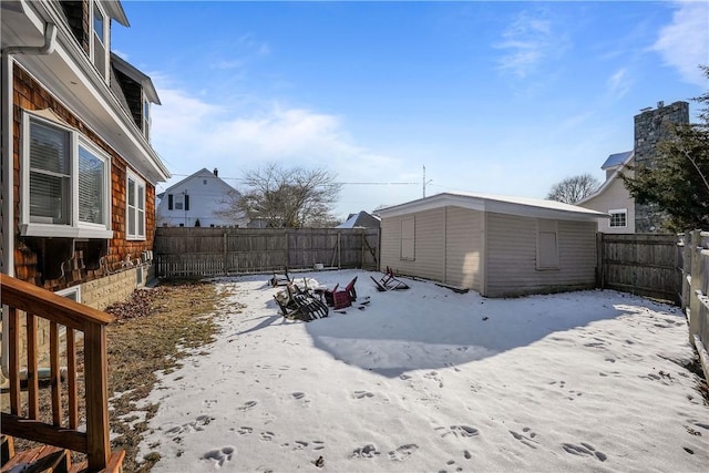 snowy yard with a shed