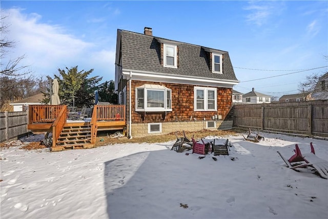 snow covered property featuring a deck