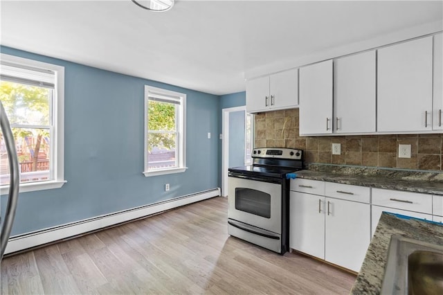 kitchen featuring white cabinetry, a baseboard radiator, dark stone countertops, and stainless steel electric range oven