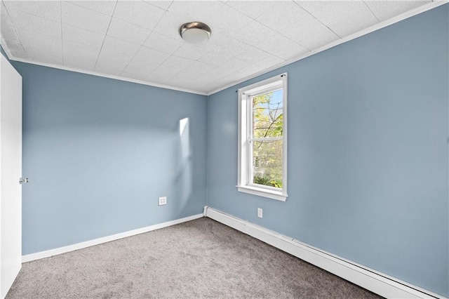 carpeted empty room with baseboard heating, ornamental molding, and plenty of natural light