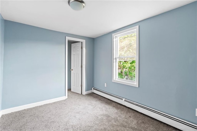 carpeted spare room with baseboard heating