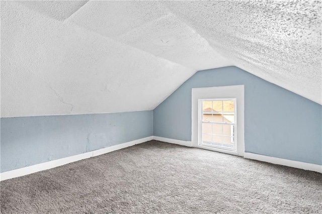 bonus room featuring vaulted ceiling, carpet flooring, and a textured ceiling