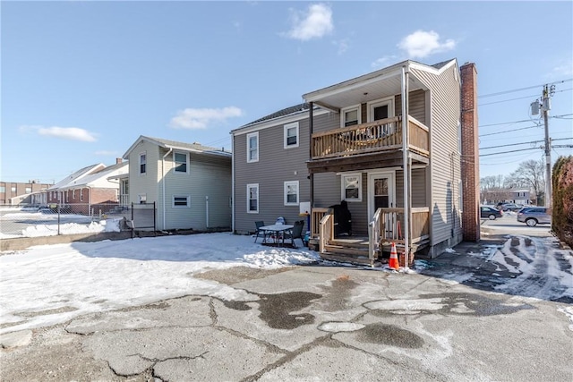 back of property with a balcony