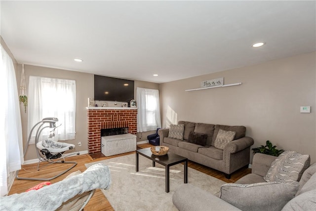 living room with hardwood / wood-style flooring and a fireplace