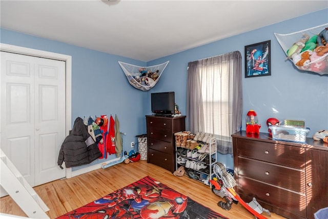 bedroom featuring hardwood / wood-style flooring and a closet