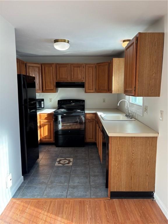 kitchen with sink and black appliances