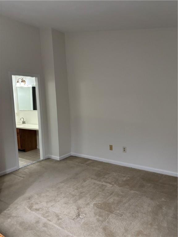 carpeted spare room featuring sink