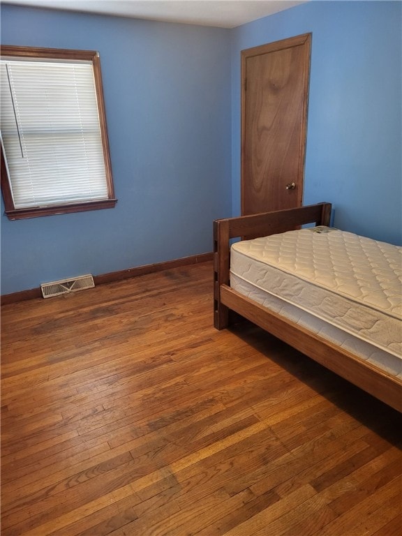 unfurnished bedroom with hardwood / wood-style floors