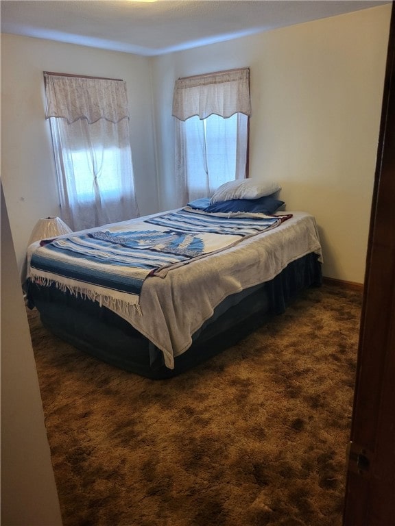 bedroom featuring dark carpet