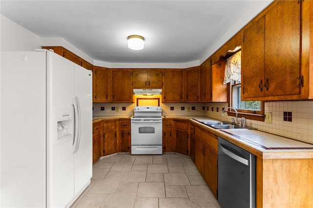 kitchen with tasteful backsplash, sink, and white appliances