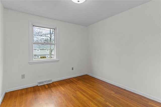 unfurnished room with hardwood / wood-style floors