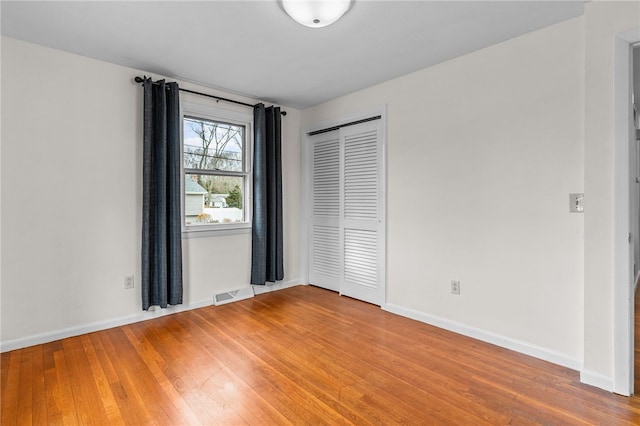 unfurnished room featuring wood-type flooring