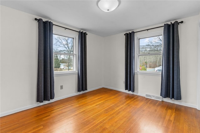 empty room with hardwood / wood-style floors