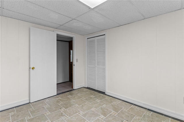 interior space featuring a paneled ceiling and a closet