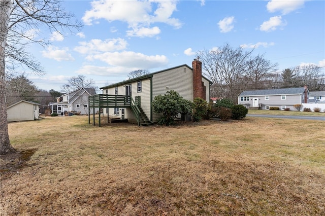 view of home's exterior featuring a wooden deck and a lawn