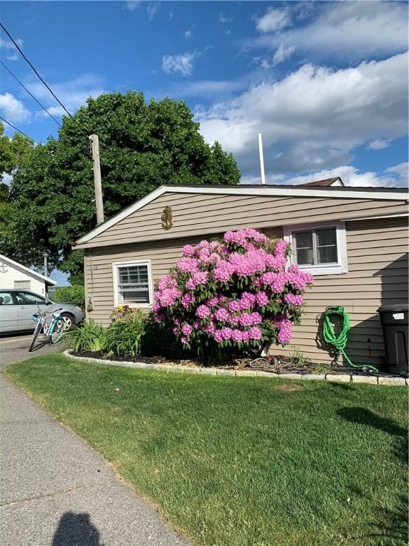 view of property exterior with a lawn